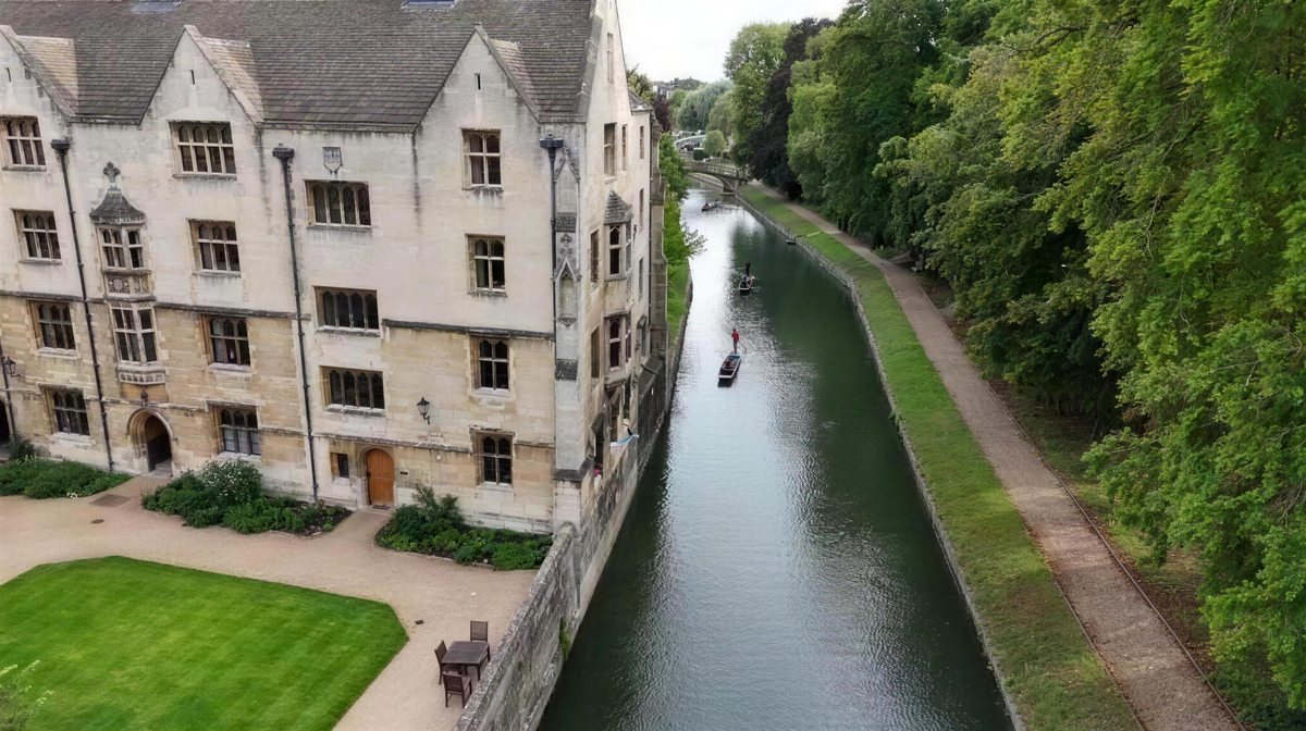Cambridge college beside the river, filmed from the air