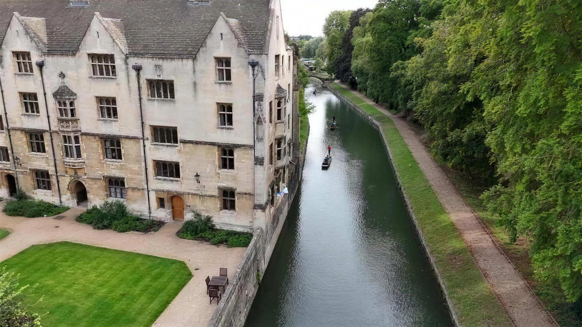 Aerial view over a Cambridge college and the river