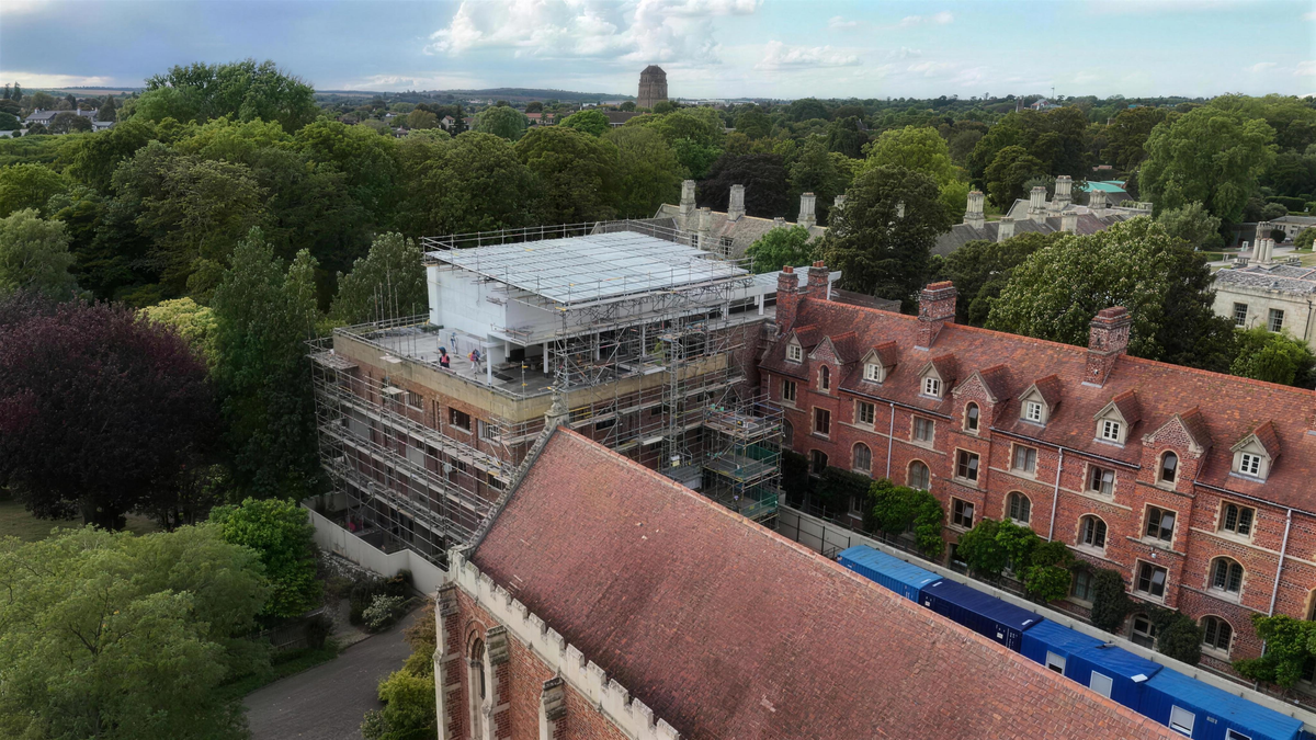 Scaffolding over a listed Cambridge college roof, filmed from the air